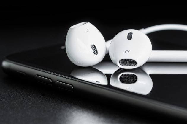 earbuds resting on mobile phone bigstock--158720390